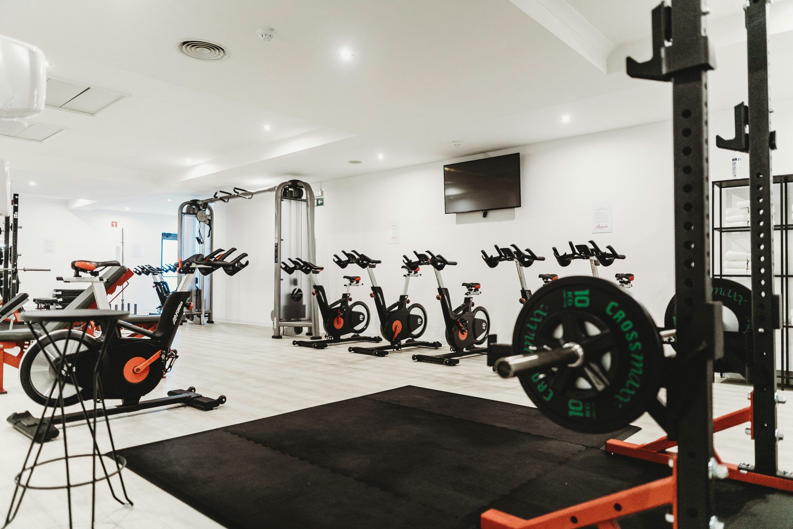 Camber Ridge has a modern gym featuring a minimalist design and high-tech exercise machines