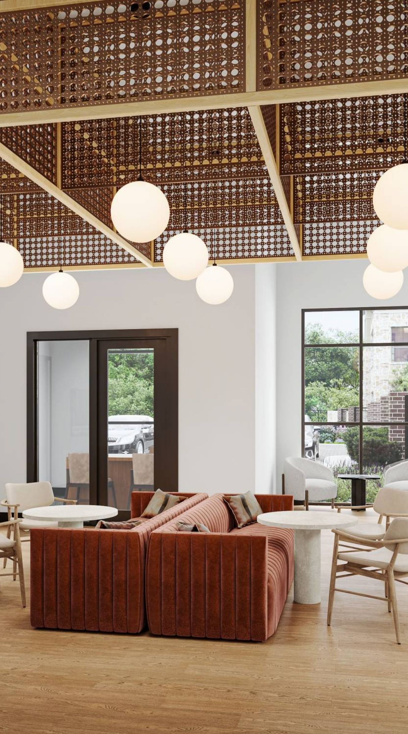 Camber Ridge Modern lounge with red sofas, wooden chairs, and a lattice ceiling featuring globe lights. Large windows let in natural light.