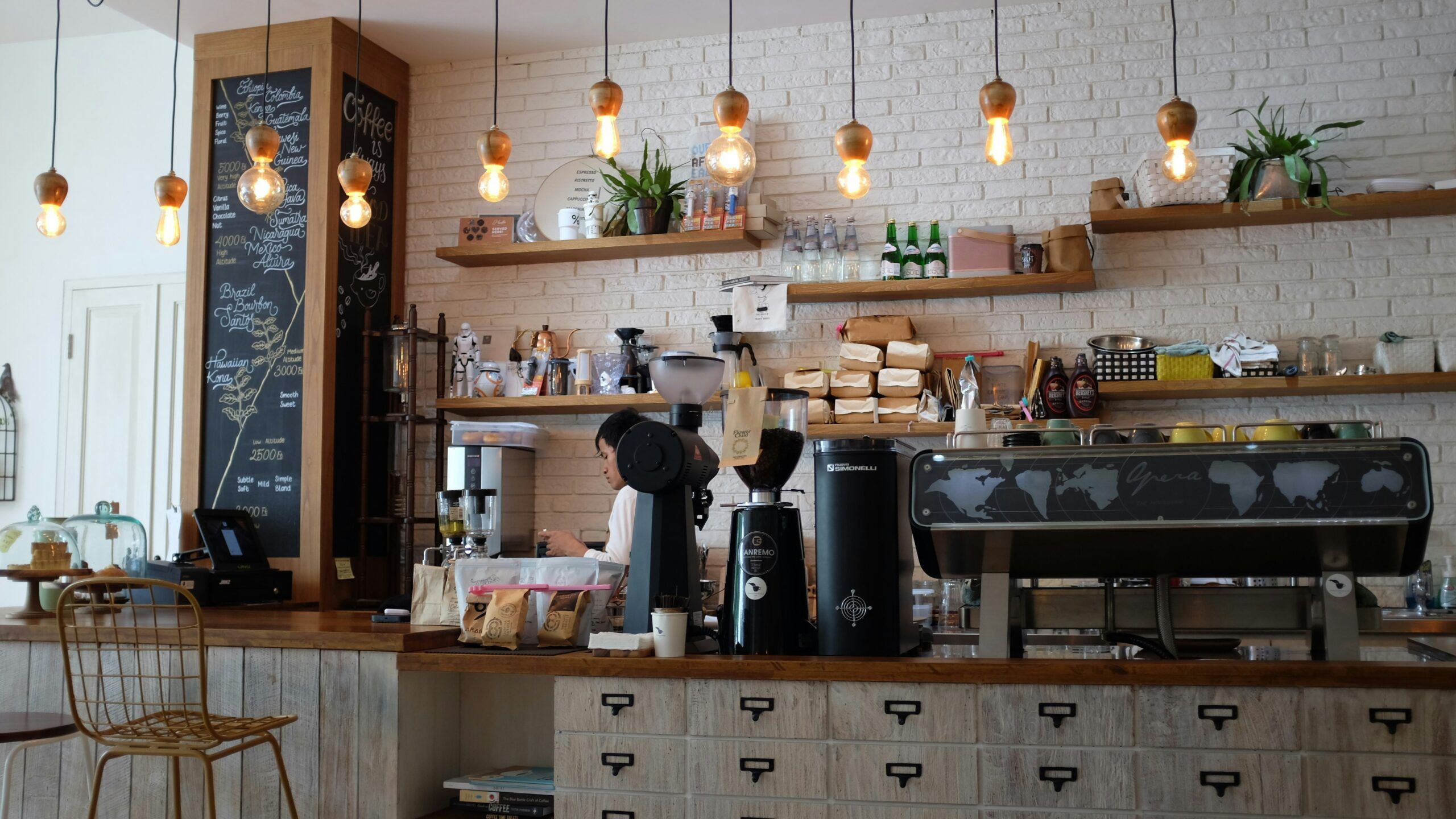 Camber Ridge Apartments,. A modern and elegant coffee shop featuring a light wood counter with black countertops.