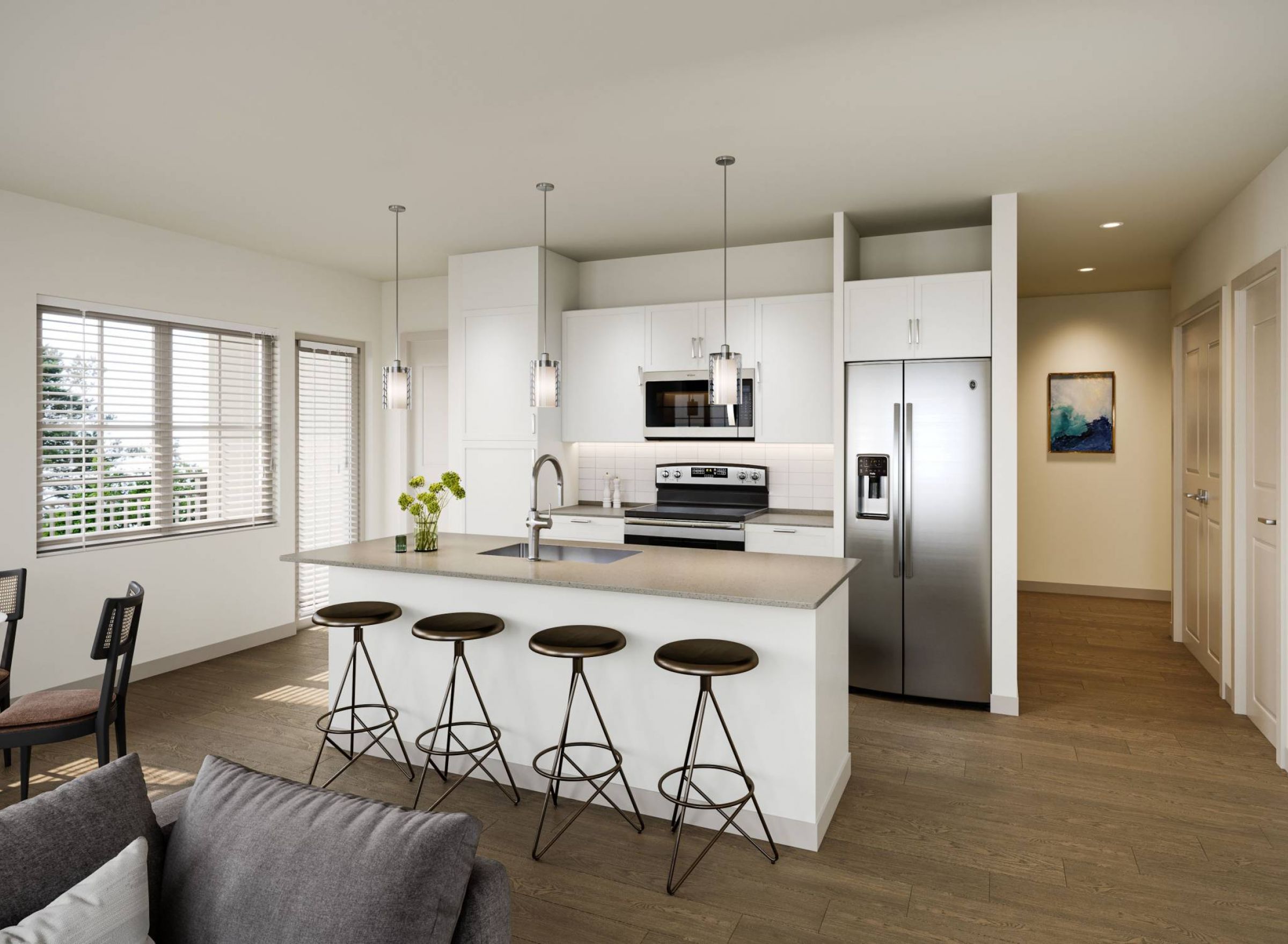 Camber Ridge Modern kitchen with white cabinets, stainless steel appliances, and three bar stools at a central island.