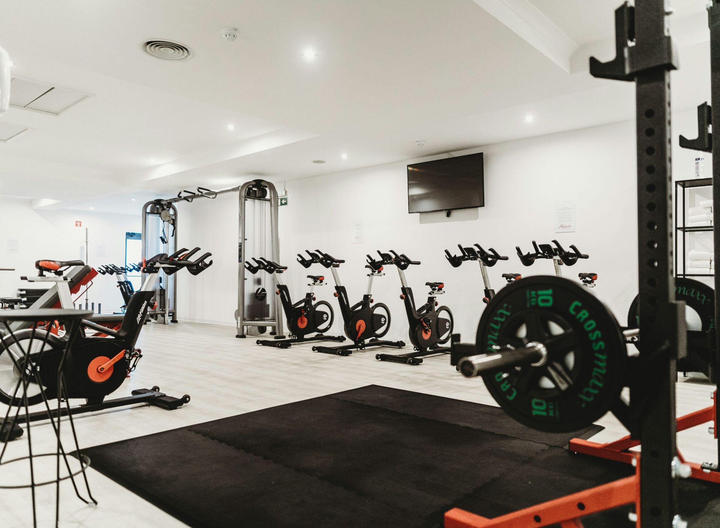 Camber Ridge A gym with exercise bikes, weight racks, and workout equipment in a well-lit room.